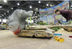 Antargran Army tank burns as the Slammers thunder past