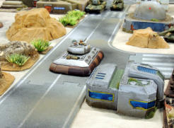 Slammers command tank rumbles down the road into town facing off NUA vehicles