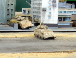 Antargran Ajax APCs (Khurasan) carefully cross a road under fire