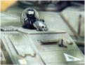 A United Defence Batteries commander in the top hatch of a GD806, armed with a tribarrel powergun