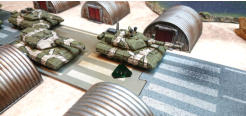 A NU-PDF Mace Heavy Tank slides between the industrial sheds and - note the green token - a Thunder Run is declared